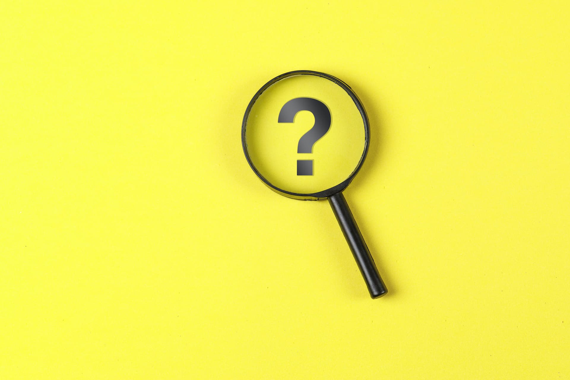 business-and-financial-concept-with-magnifying-glass-question-mark-on-yellow-background-flat-lay (1)